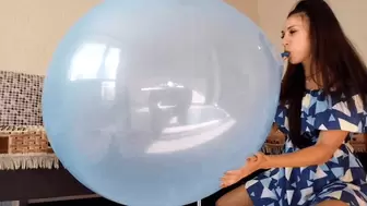 A huge blue balloon bursts with a bang on Darina's lips