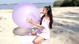 Plump lips will tear a purple balloon on the shore of the lake