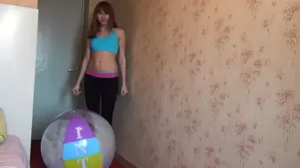 Svetlana blows an inflatable ball