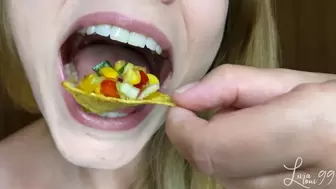 Colorful salad with nachos closeup chewing full HD mp4