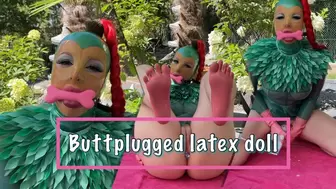 Buttplugged latex doll