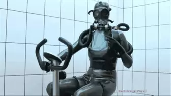Sexy girl in heavy rubber outfit with gas mask makes sport