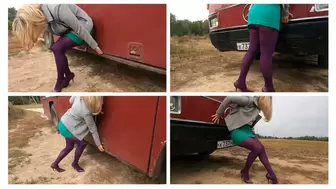 Strong girl pushes a heavy bus