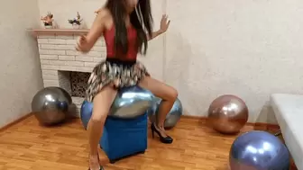 Popping balloons with her ass