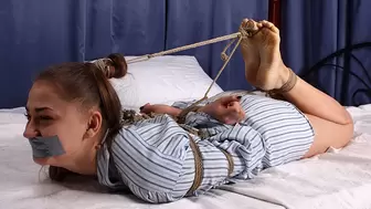 Tapegagged barefoot Rose, hogtied with her big toes connected with rope to her hair tie, is wiggling on the bed, almost unable to move (HD MOV)