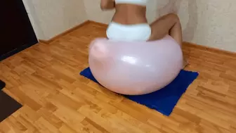 Jumping on a pink balloon