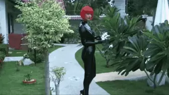 Hot red hair rubber girl in black latex catsuit walk by the pool
