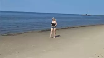 Big ass in denim shorts on the beach