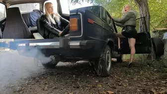 Two blondes makes exhaust fumes to the guy behind the car