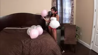 Sexy school girl sits to pop her balloons