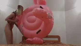 Alla is blowing up a big inflatable flamingo with her mouth!!!