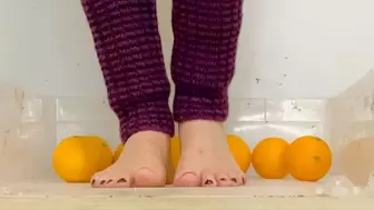 Barefoot crush oranges very slowly Ashley