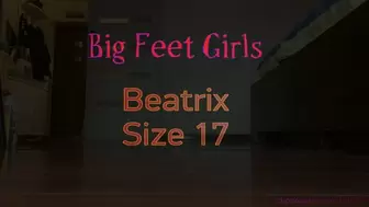 Amazon Beatrix comparing her size 17 feet to objects - soles view