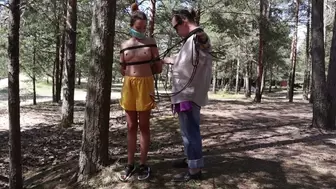 Sofi in yellow shorts tied with black ropes in the forest_ Part 1