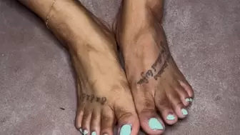 Ebony lotions, oils, and massages her feet
