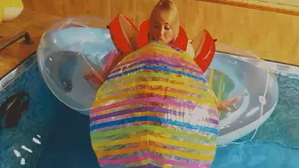 Alla inflates a large rare beach ball with her mouth and floats on an inflatable boat in the pool!!!