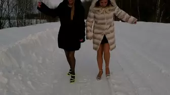 Two sexy girls on the slippery icy road on very high heel sandals