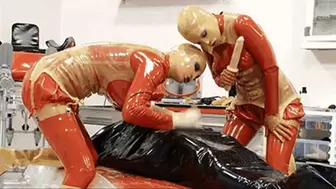 Two latex goddess and the slave catheterised in inflatable rubber - Part 2 of 2 - The catheter and the piss