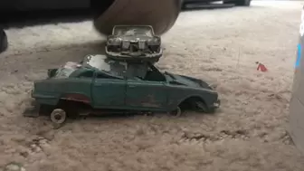 Metal toy car crush with heels close up