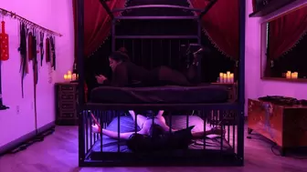 slave is bound, edged, plugged and ignored under Mistress Rogue's Bondage bed