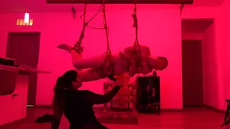 slave falls into Mistress Rogue's shibari suspension web and gets dominated