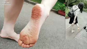 Poor barefoot girl Suyu walks on a gravel road