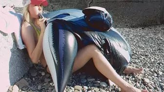 Alla inflates a big black inflatable whale on the beach with her mouth!!!