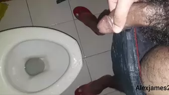 Guy peeing in the toilet with a hard dick
