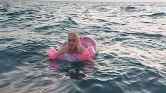 Alla swims in the sea with an inflatable ring and inflatable arm bands for safety!!!