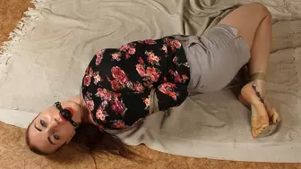 Gagged with black ball gag barefoot Amanda in shirt and shorts, hogtied with her hands in reverse prayer, wriggles and rolls on the floor (HD MP4)