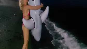 Alla blows off a black inflatable whale at night on the beach!!!