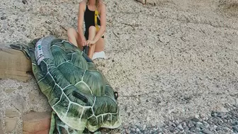Alla inflates a large inflatable turtle on the beach with a hand pump!!!