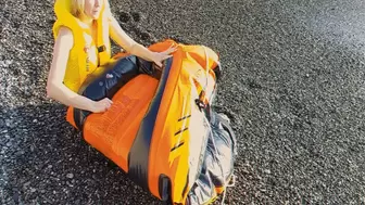 Alla deflates an orange inflatable boat on the beach!!!