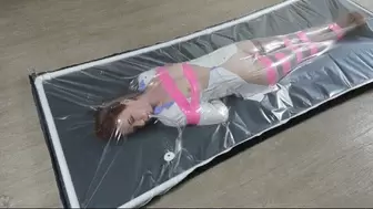 The orgasms of a doctor in a polyethylene bed in a pink bondage with a vibrator